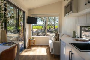 a kitchen and living room in a tiny house at Chalky's Retreat in McLaren Flat