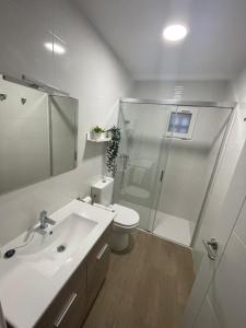 a bathroom with a shower and a toilet and a sink at El Rincón del Mirador in Carboneras de Guadazaón
