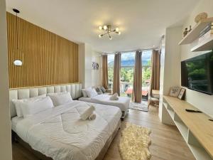 a bedroom with two beds and a flat screen tv at Valencia Cozy Suites in Valencia