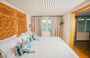 a bedroom with a white bed with pillows on it at SPECTACULAR Bay View Marea 1-1 in Culebra