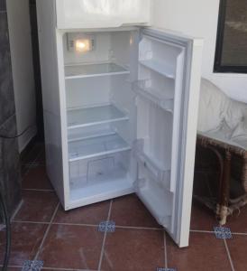 an empty refrigerator with its door open in a room at Torreón 3 - Habitación cerca del aeropuerto con alberca in Torreón