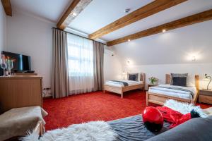 A bed or beds in a room at Boutique Hotel Vila Lieska