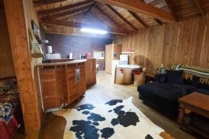 a living room with a cow rug on the floor at That 70s Cabin Yellow Rose Canyon in Mount Enterprise