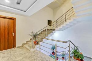 a staircase in a house with a wooden door at Collection O Yamuna Palace Near Gomti Riverfront Park in Lucknow +64 photos