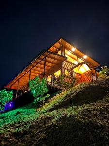 a house on top of a hill at night at Casa Buena Vista San Gerardo de Dota in San Gerardo de Dota