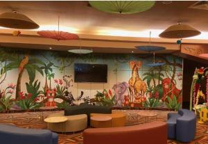 a lobby with a mural of animals on the wall at Cataleya Luxury Room's in Bucharest