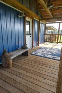 a porch with a bench on a wooden deck at The Blues House Yellow Rose Canyon in Mount Enterprise