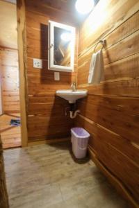 a bathroom with a sink and a mirror at Barn 2 Yellow Rose Canyon in Mount Enterprise +6 photos