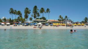 a group of people in the water at a beach at Cobertura Porto de Galinhas in Porto De Galinhas