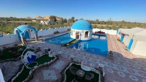 arial view of a villa with a swimming pool at Papy house in Siwa