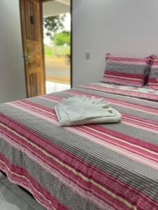a pair of beds with towels on top of them at Hotel Fazenda Bonito in São Vicente