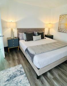 a bedroom with a large bed with two night stands at Oasis near Miami International in Miami
