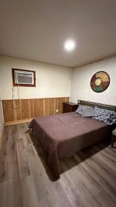 a bedroom with a large bed in a room at Redwood Cabin Yellow Rose Canyon in Mount Enterprise +8 photos