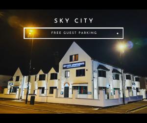 a sign that reads sky city free guest parking at Sky City Apartments in Coventry
