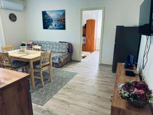 a living room with a table and a couch at Robin Apartman in Pécs