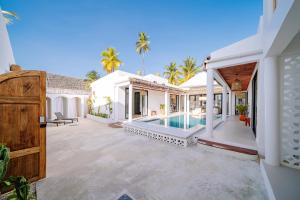 an exterior view of a house with a swimming pool at Marram Villas Prime Location in Paje
