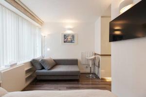 a living room with a couch and a chair at Apartments Craven Terrace in London