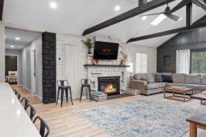 a living room with a couch and a fireplace at NewReno 8BR 6BTH DECK GAMES PETS in Lake Harmony +101 photos