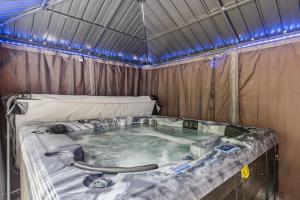 a hot tub in a tent with blue lights at Twin Chalet 6 BDs Hot Tub Game Area and more in Albrightsville