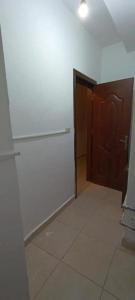 a room with a white wall and a door at Furit apartment in Mazār Abū ‘Ubaydah +5 photos
