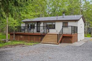 a house with a large porch and stairs in front at The Cozy Cubhouse Perfect Couples Getaway in Thornhurst