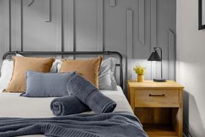 a bedroom with a bed with pillows and a table at Cabin in the Skye - 5 BDs Lake Harmony in Lake Harmony