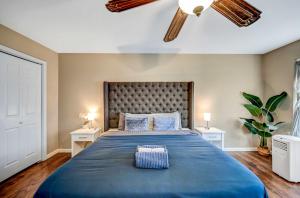a bedroom with a large blue bed with two night stands at Spacious Retreat - Outdoor Oasis Games and more in Blakeslee