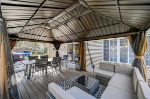 a screened in porch with a couch and chairs at Spacious Retreat - Outdoor Oasis Games and more in Blakeslee