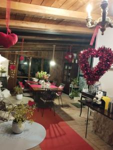 a room with tables and chairs with hearts on the wall at Petalo Rosso b&b in Lenola