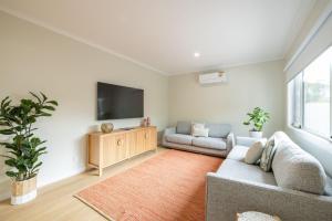 a living room with a couch and a flat screen tv at Aberdeen in Cowes
