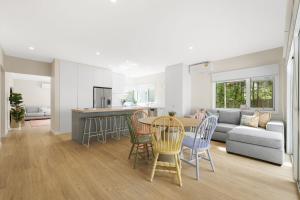 a kitchen and living room with a table and chairs at Aberdeen in Cowes
