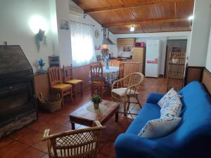 a living room with a blue couch and a table at Agroturismo El Serrano in Moratalla