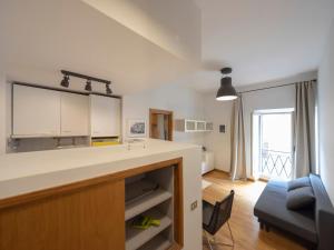 a kitchen with a counter and a living room at Spanish Steps, Suite Dominic, Strollingrome in Rome