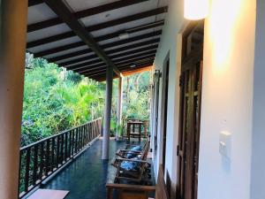 a balcony of a house with benches on it at Sh li in Sigiriya