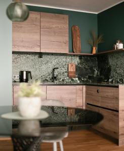 a kitchen with green walls and a counter top at Apartment Chiusa in Chiusa