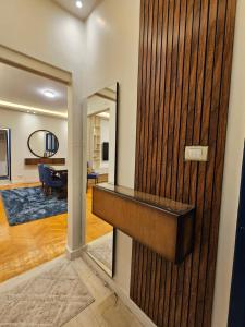 a wooden wall with a mirror in a room at شقة بوسط المدينة الدقي in Cairo +3 photos