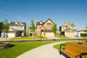 a park bench in front of a large house at Havenly Homes DMV in Arlington