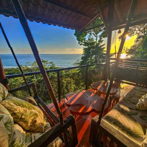 a room with a balcony with a view of the ocean at La Uvita Perdida in Uvita +36 photos