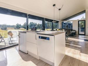 an open kitchen and living room with large windows at 9 person holiday home in Væggerløse-By Traum in Marielyst