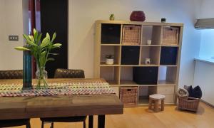 a dining room with a table and a book shelf at Hall Farm Barns in Monk Fryston