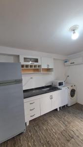 a kitchen with a refrigerator and a washing machine at Loft García in Mendoza
