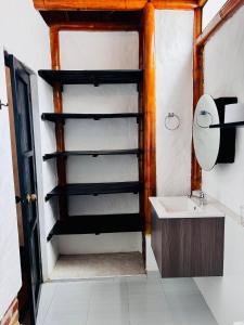 a bathroom with a sink and a mirror at Cabaña Familiar El Refugio Tauramena in Tauramena
