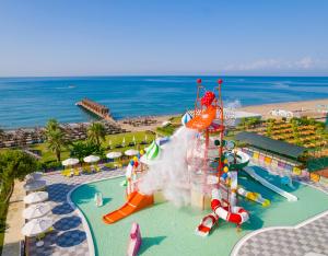 a water park with a water slide on the beach at Kremlin Palace in Lara