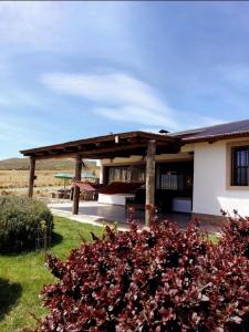 a house with a porch with a swing at Casa Pradera de los Andes in Tupungato