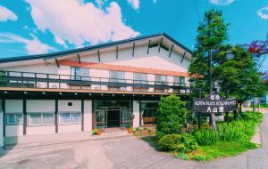 un condominio con un cartello di fronte di AlpenBlick入山登 a Hakuba