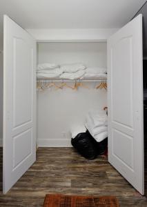 a room with a closet with white walls and shelves at Lovely 3-Bedroom Apt in the Heart of Brooklyn in Brooklyn