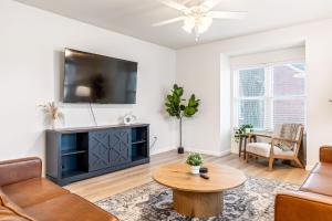 a living room with a tv and a table at Renovated House for 14 in Wentzville MO in Wentzville