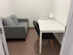a living room with a couch and a table with a desk at Casa de Casarelhos - Estúdio Piso 0 ou AL Piso 1 - "Gerês" in Geres +138 photos