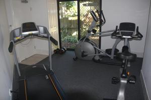 a room with a chair, a table, and a large mirror at Mariners Resort Kings Beach in Caloundra