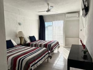 Ένα ή περισσότερα κρεβάτια σε δωμάτιο στο Hotel Independencia